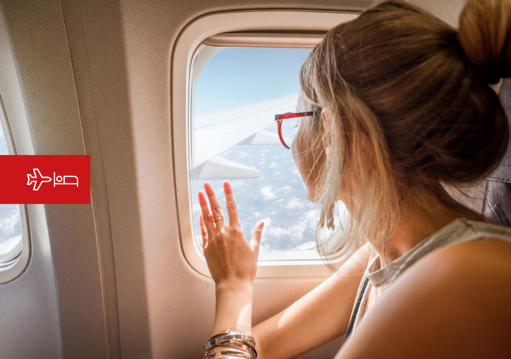 Woman looking out the airplane window en route to Tenerife.