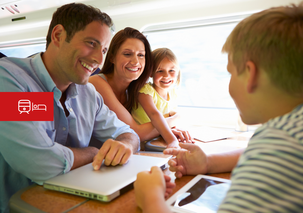 Family smiling and chatting inside a train. Red train and bed icons displayed.