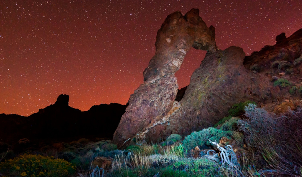 Arch-shaped rock under a starry sky in Teide National Park, Tenerife.