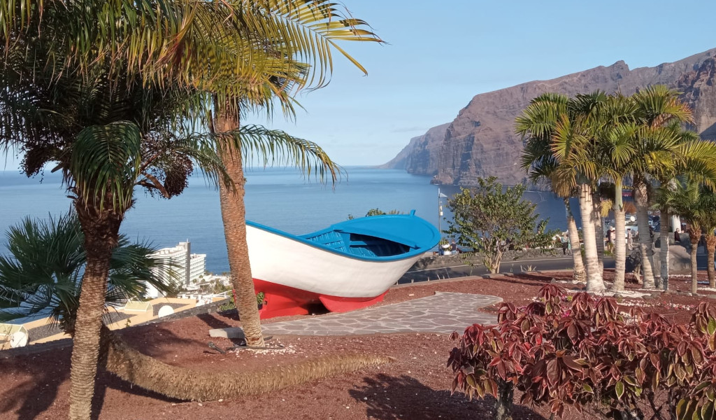 Blue and white boat in a park with views of Los Gigantes, Tenerife.