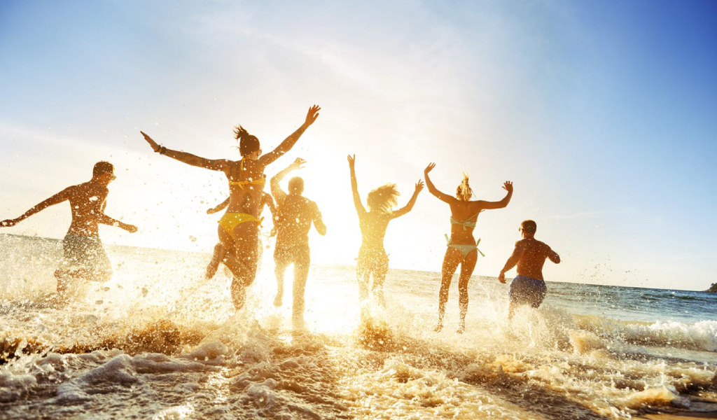 People running on the seashore on a beach in Tenerife.