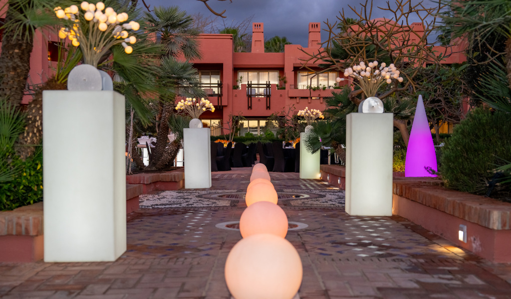 Illuminated entrance at sunset with plants and lights at a hotel in Tenerife.