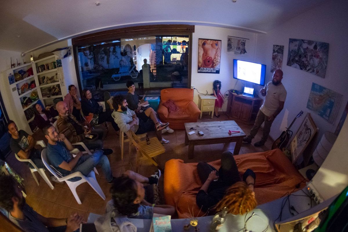Group of people attending a presentation in a living room in Tenerife.