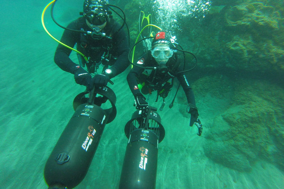Divers with propulsive diving equipment in the waters of Tenerife.