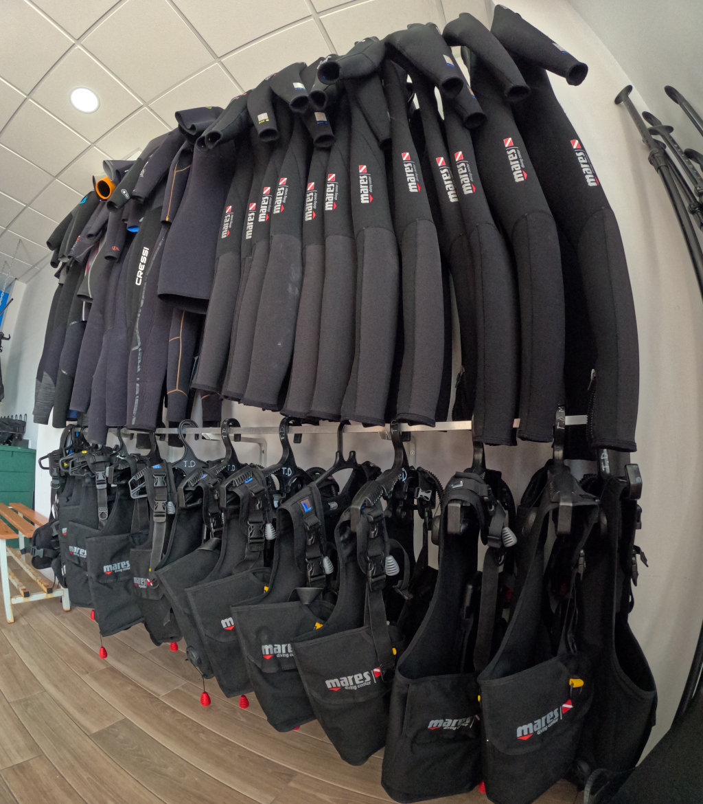 Diving suits and vests hung in a diving center in Tenerife.