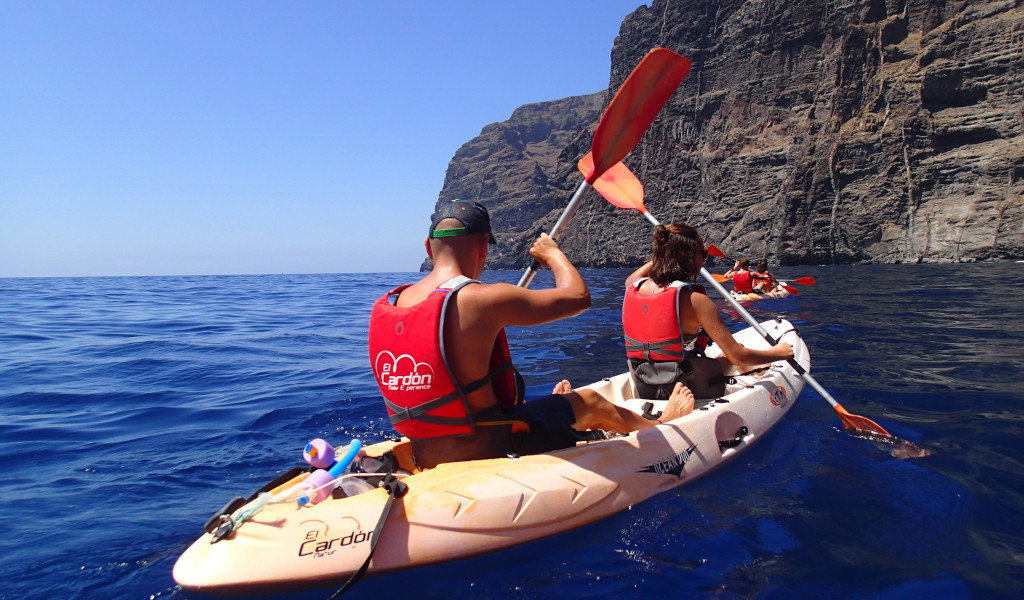 People paddling a kayak near the cliffs of Los Gigantes, Tenerife.