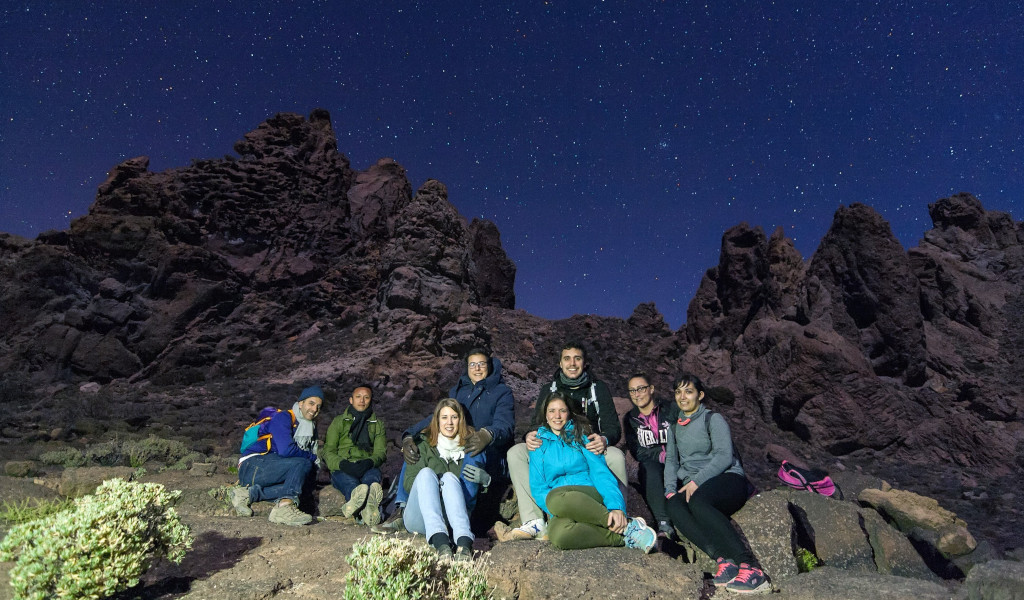 Group of people under stars in the Teide National Park, Tenerife.