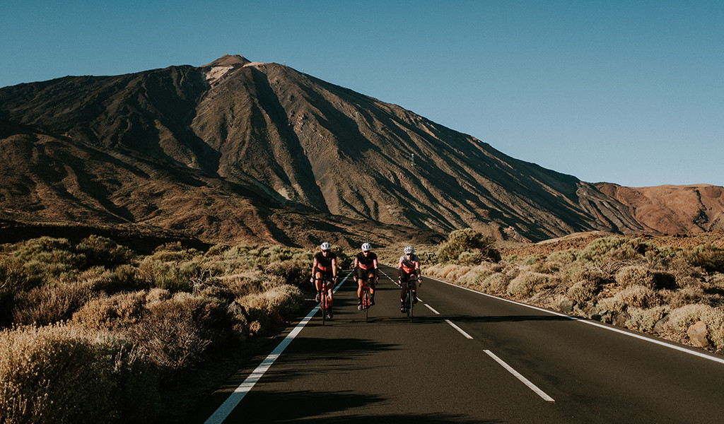 Cyclists on the road to Mount Teide, Tenerife, with the mountain in the background.