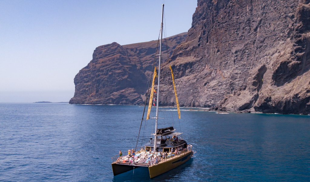 Catamaran sailing near the cliffs of Los Gigantes in Tenerife.