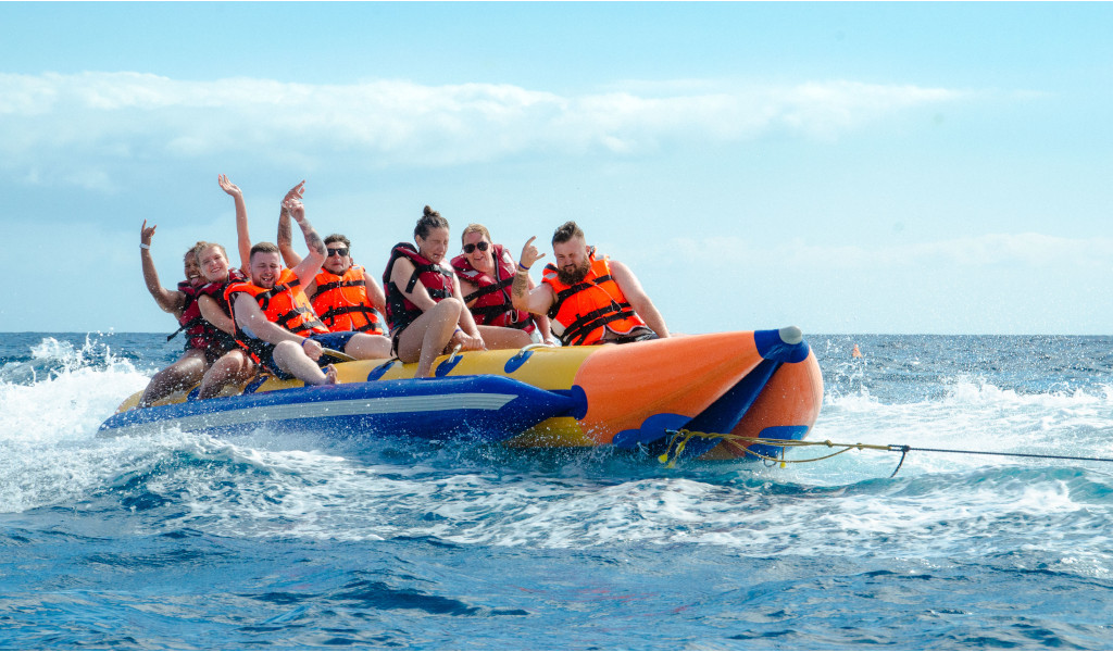 People on an inflatable banana boat over the sea at a water activity in Tenerife.