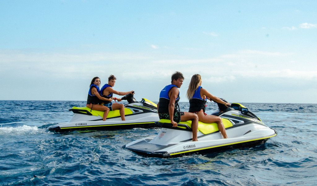 People driving jet skis in the sea near Tenerife.