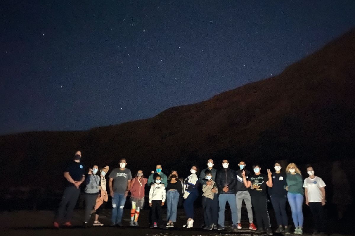 Group stargazing under the night sky in Tenerife.