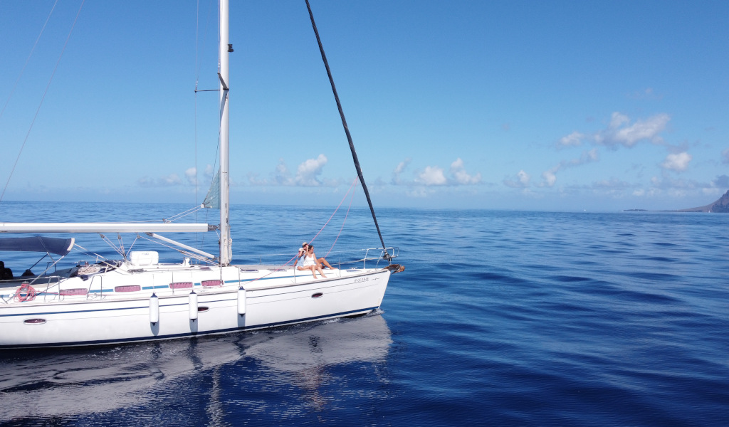 Sailboat sailing in the waters of Tenerife under a clear sky.