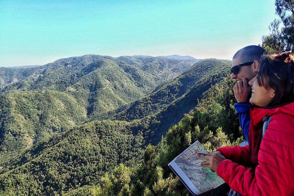 Two people look at a map on the mountain of Anaga, Tenerife.