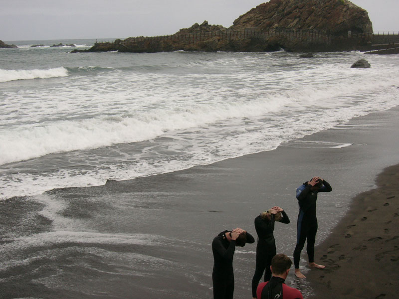 People in wetsuits on the beach El Roque de las Bodegas, Tenerife.