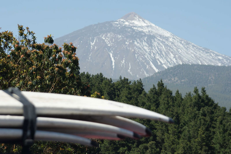 Surfboards stacked with Mount Teide in the background in Tenerife.