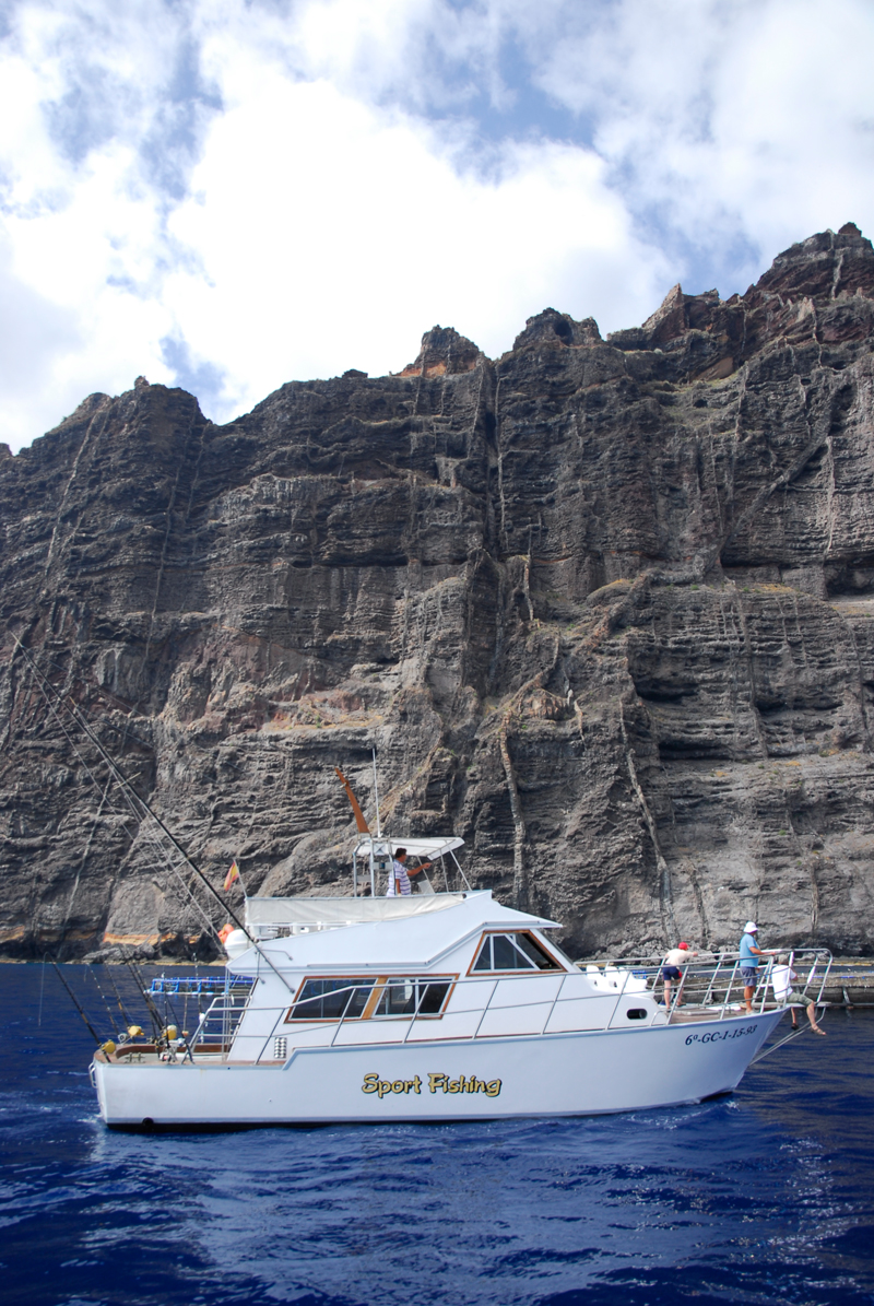 Sport fishing boat in front of the cliffs of Los Gigantes, Tenerife.