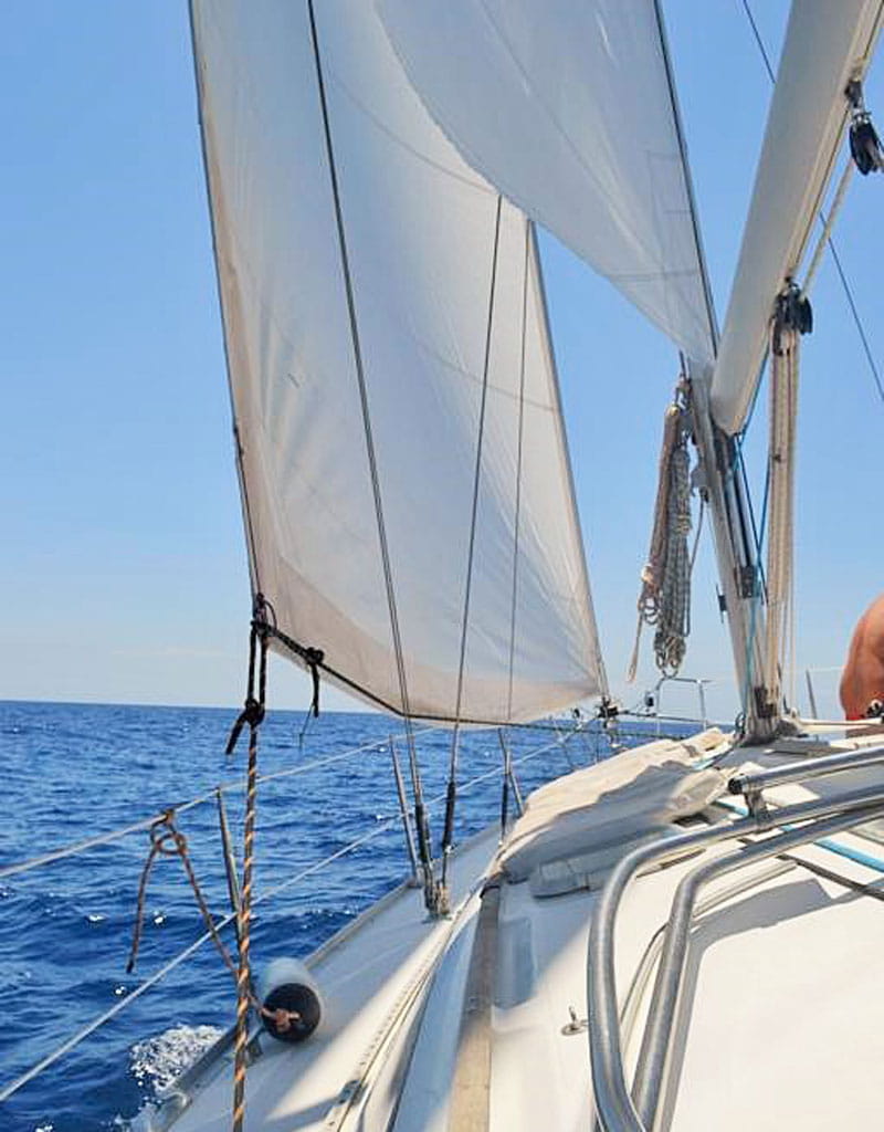 Sailing on a sailboat in the sea near Tenerife with clear skies.