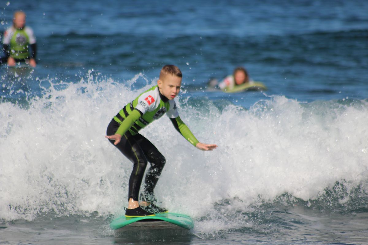 Boy surfing on a small wave in Tenerife.