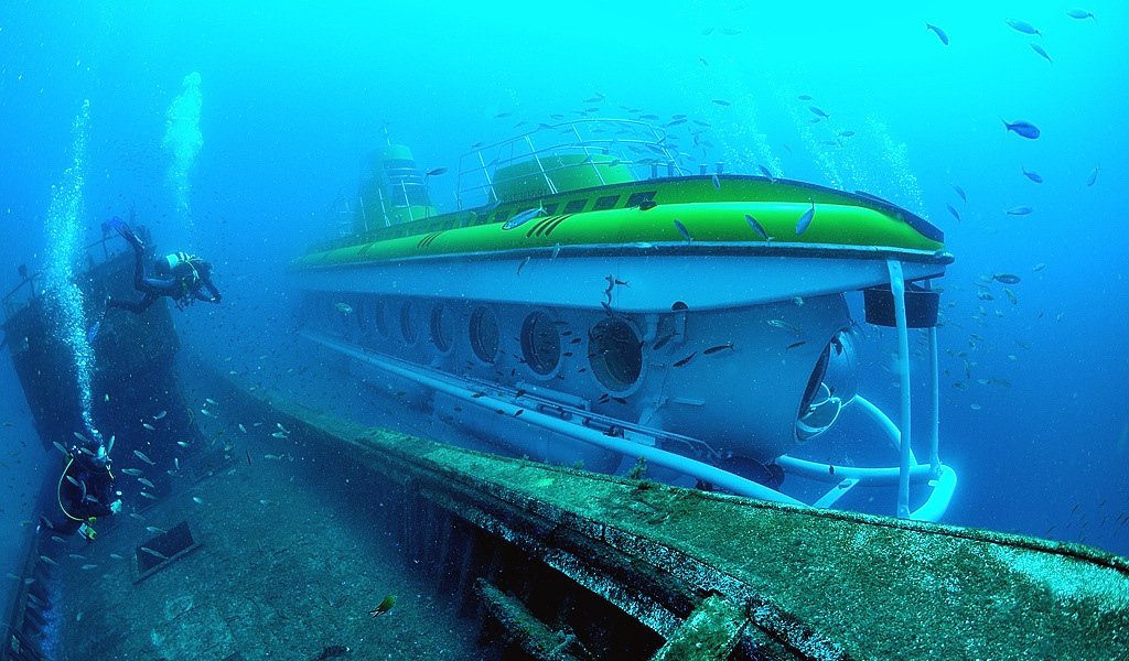 Submarine and underwater divers in the waters of Tenerife.