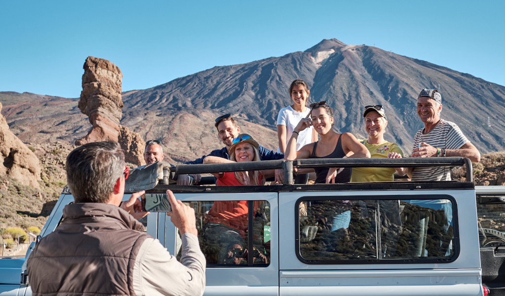 Group of people in a jeep in front of Mount Teide in Tenerife.