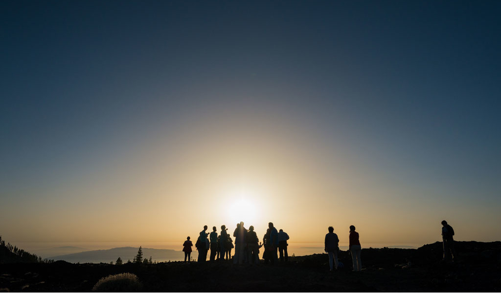 People watching the sunrise at a viewpoint in Tenerife.