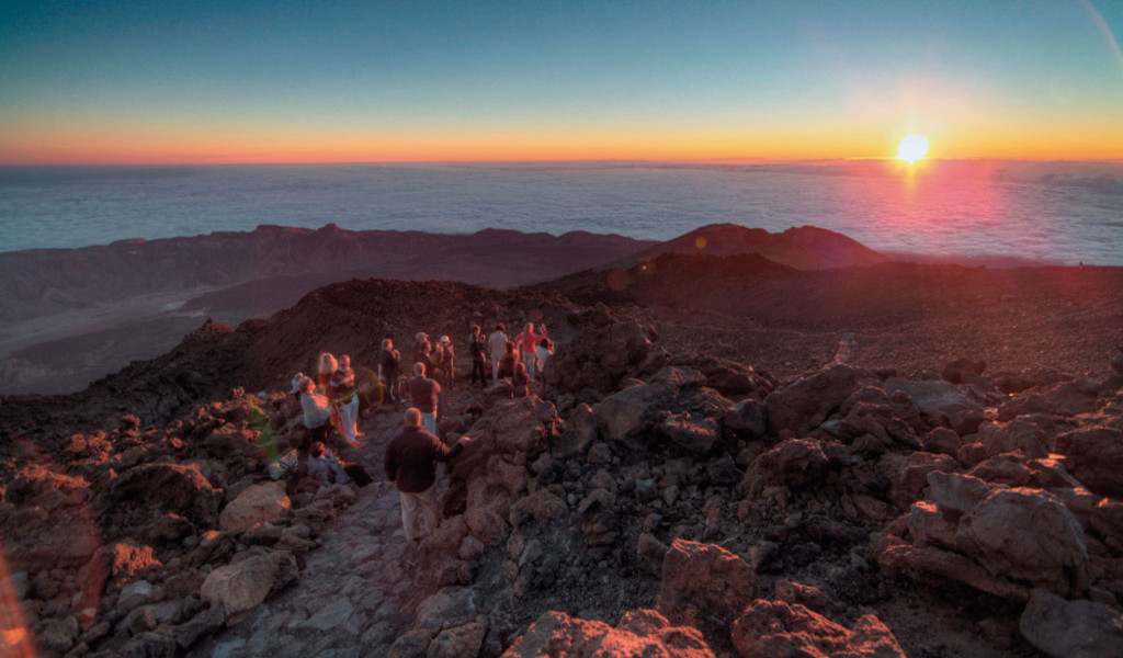 Group of people watching the sunrise on Mount Teide, Tenerife.