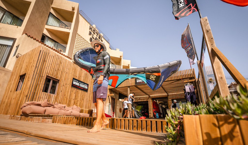 Person holding windsurfing equipment at Hotel Playa Sur in Tenerife.