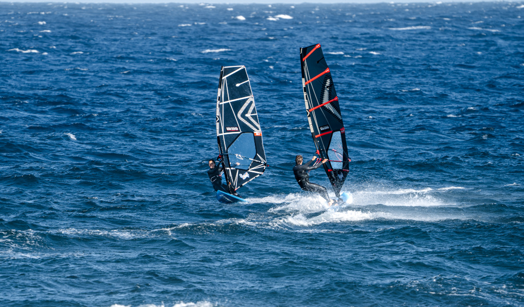 Two people windsurfing in the sea of El Médano, Tenerife.