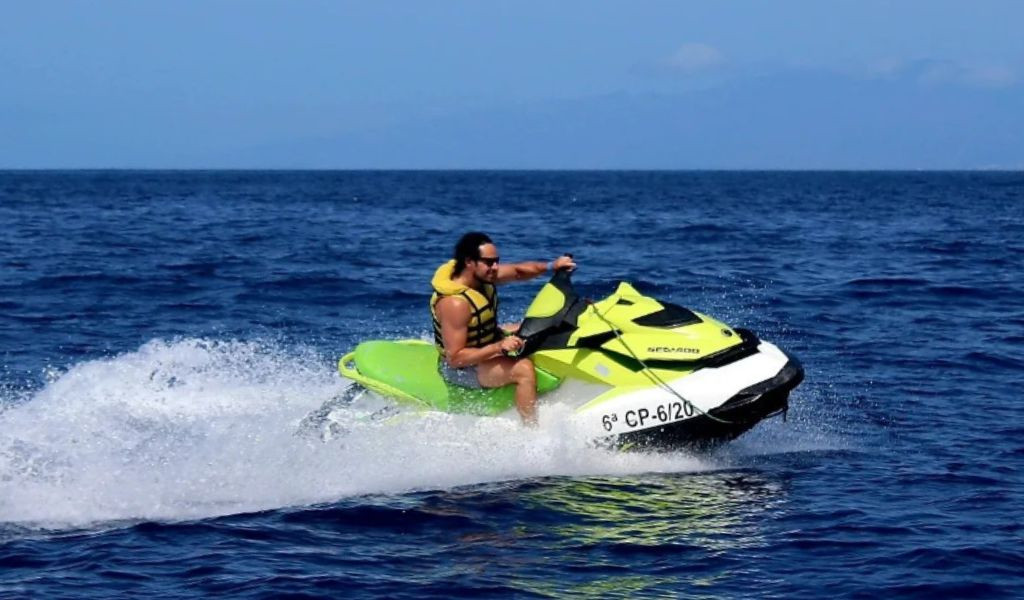 Person driving jet ski in the sea of Tenerife. Visible text: 6th CP-6/20.