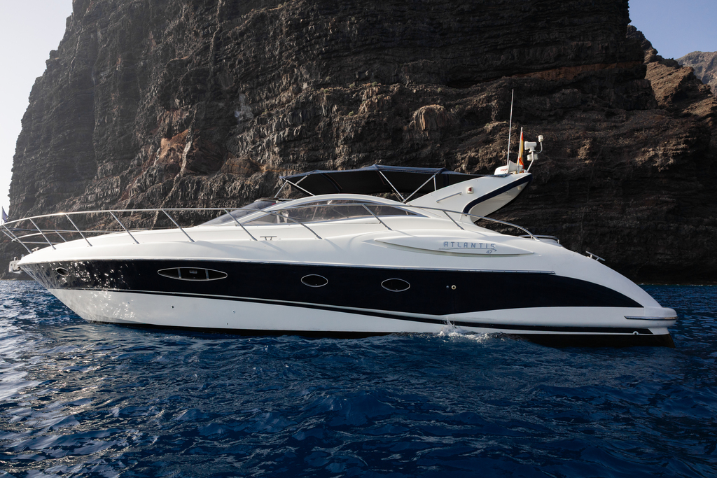 Atlantis yacht in the water in front of the cliffs of Los Gigantes, Tenerife.