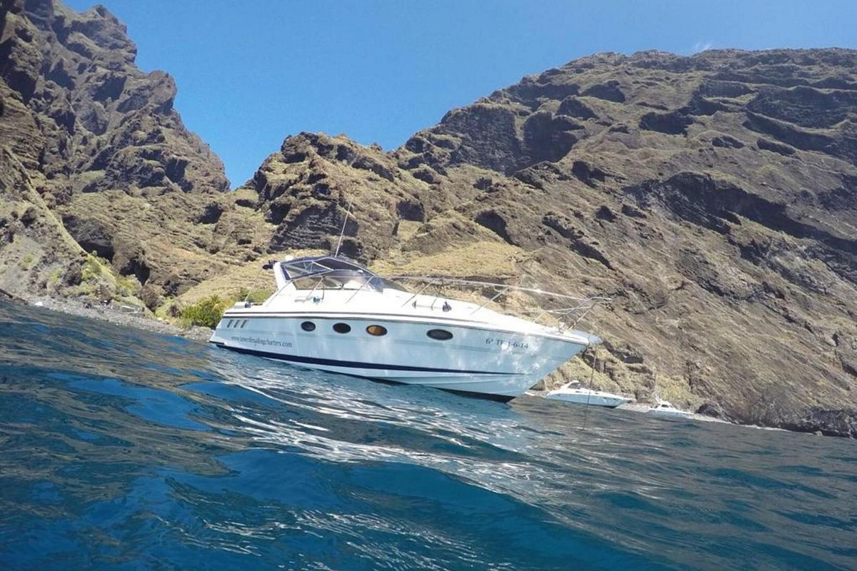 Boat anchored in front of the cliffs in Tenerife.