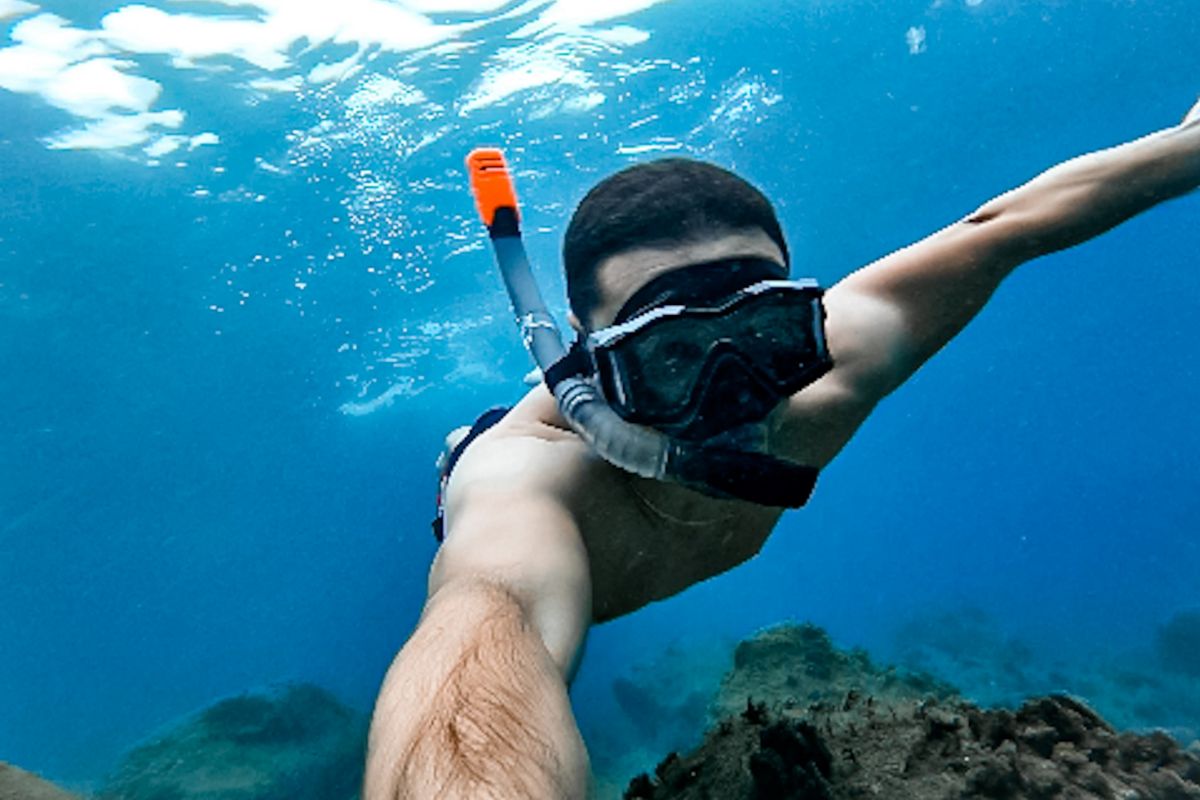 Person diving in crystal clear waters near Tenerife.