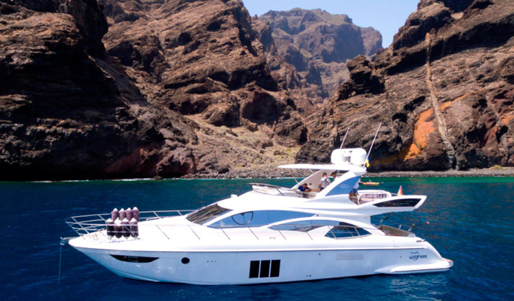 Yacht sailing in front of the cliffs of Los Gigantes, Tenerife.