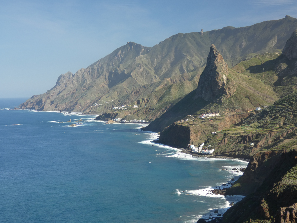 Tenerife's mountainous coastline with blue waters and green cliffs.