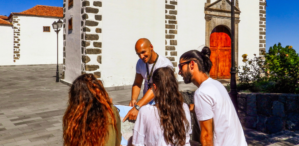 Group of people looking at a map in front of a church in La Laguna, Tenerife.