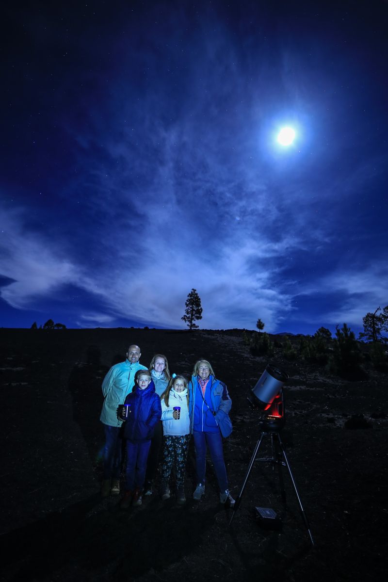 Group of people with telescope observing the night sky in Tenerife.