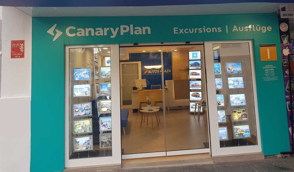 Entrance of the CanaryPlan store in Tenerife, with posters for excursions.