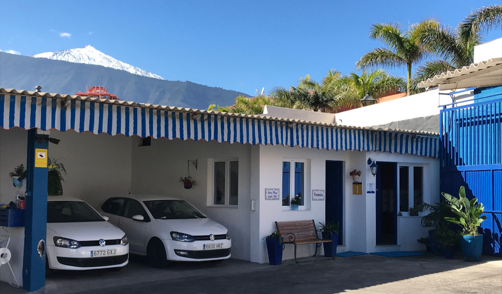 Parking with cars and views of Mount Teide in Puerto de la Cruz, Tenerife.
