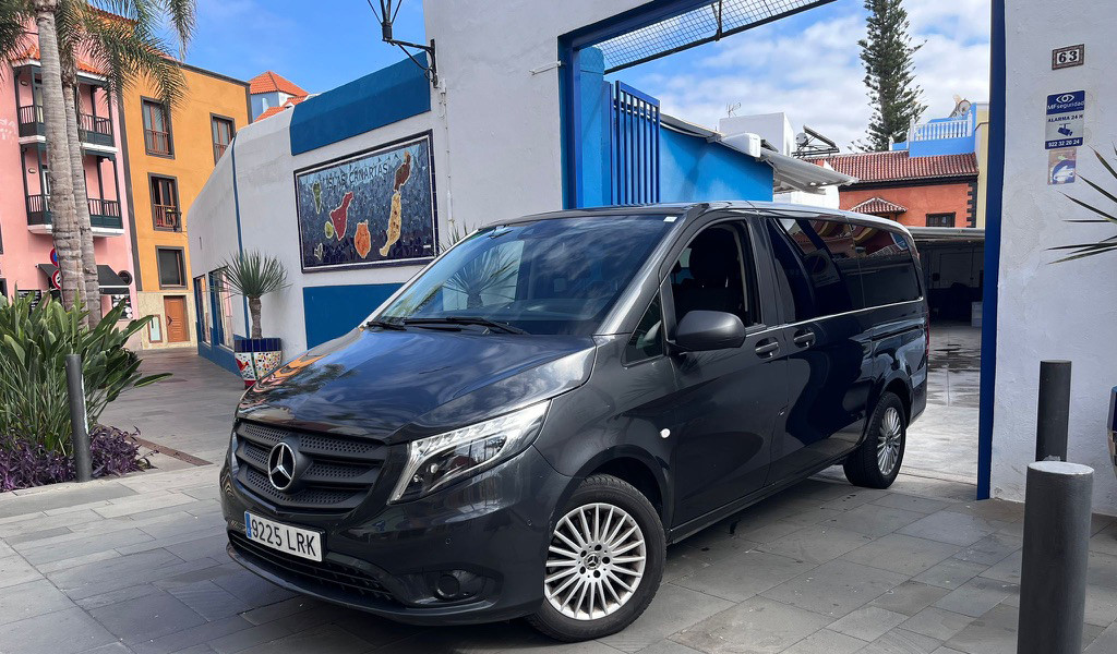 Mercedes van outside colorful complex in Tenerife.