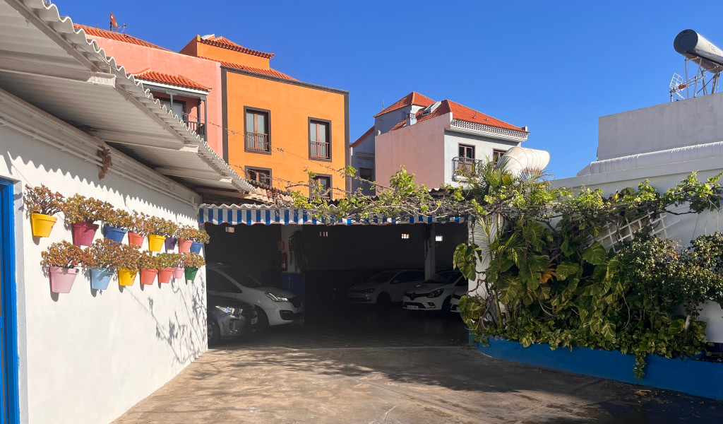 Parking lot with colorful plants and pots in Tenerife.
