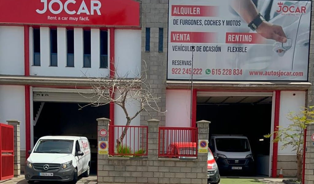 Façade of Jocar in Tenerife with advertisements for the rental and sale of vehicles.
