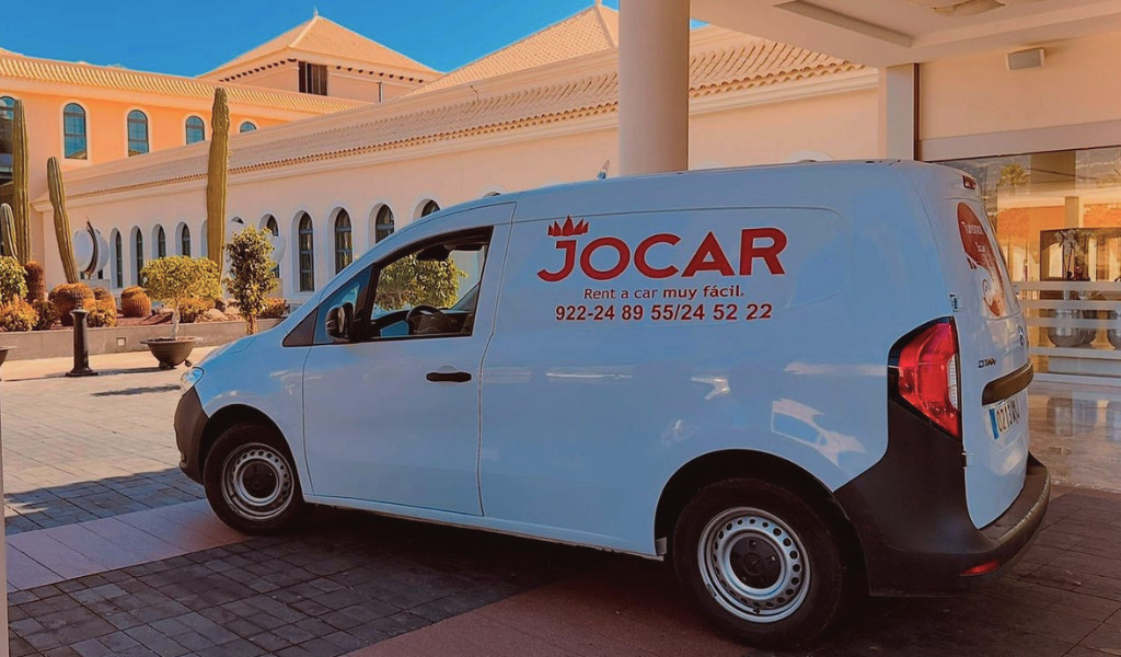 Jocar rental van parked in front of a building in Tenerife.
