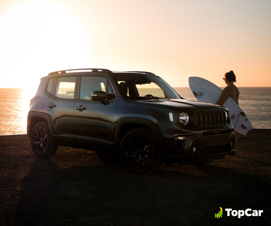 Car parked at sunset next to surfer on the coast of Tenerife.