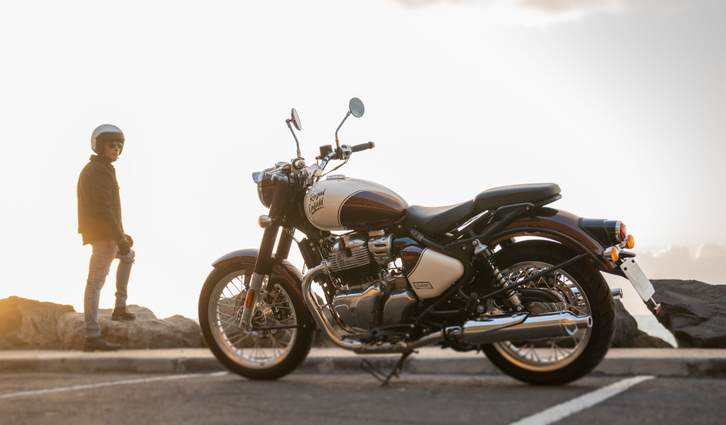 Parked motorcycle with person standing in the background at sunset in Tenerife.