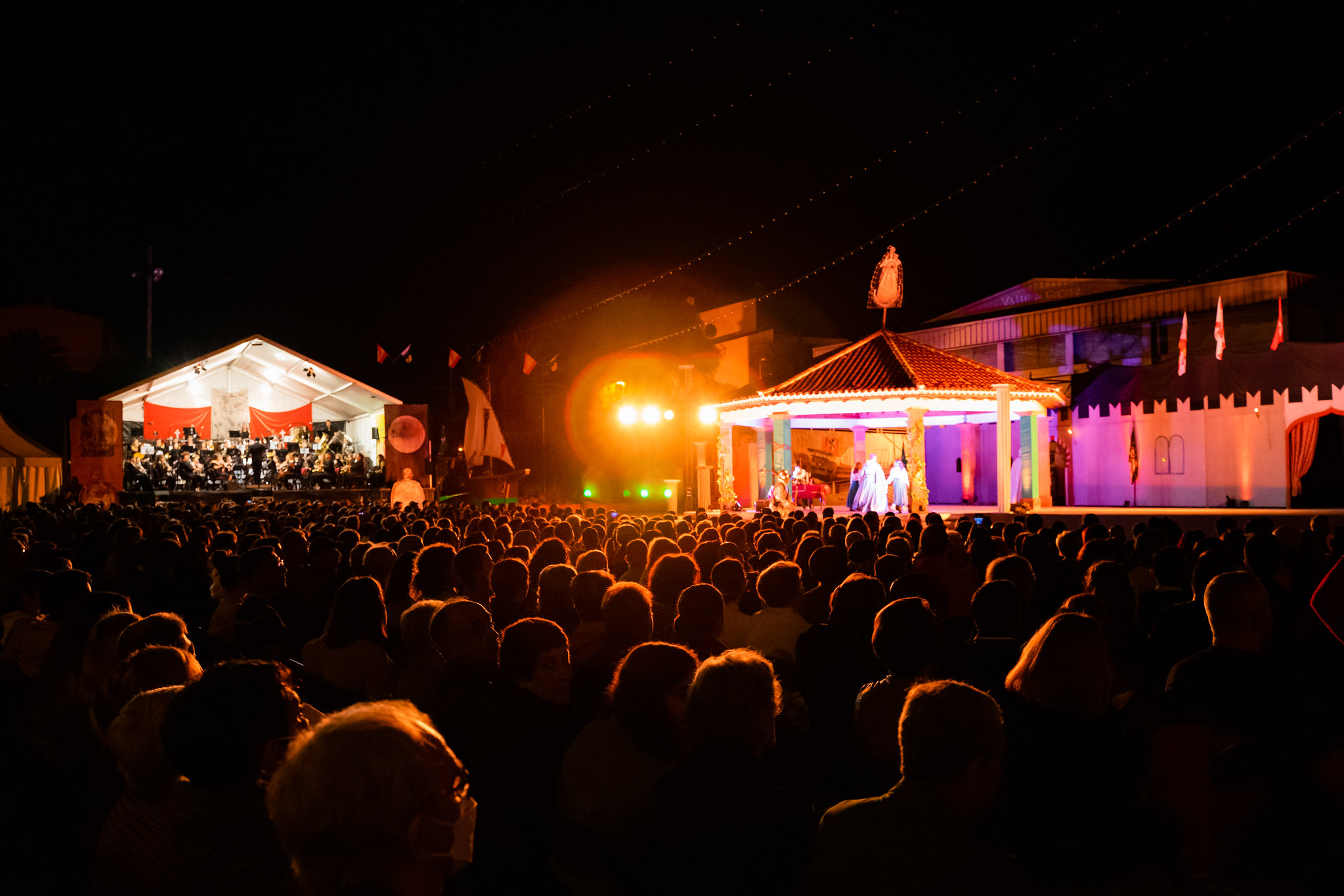 Night festival on an illuminated stage in Valle de Guerra, Tenerife, with an audience.