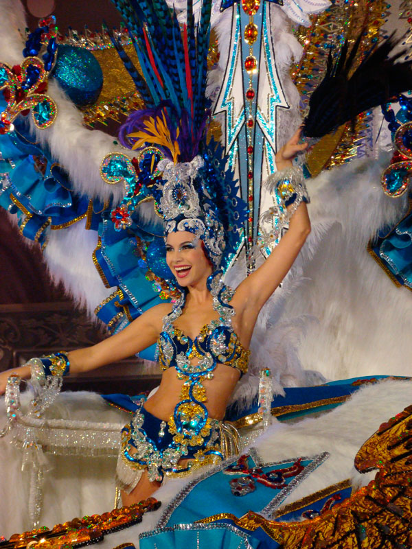 Carnival troupe in Tenerife with a colorful costume of feathers and sequins.