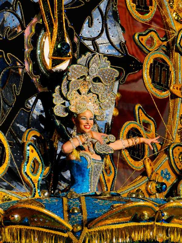 Person in colorful costume at Tenerife Carnival parade.