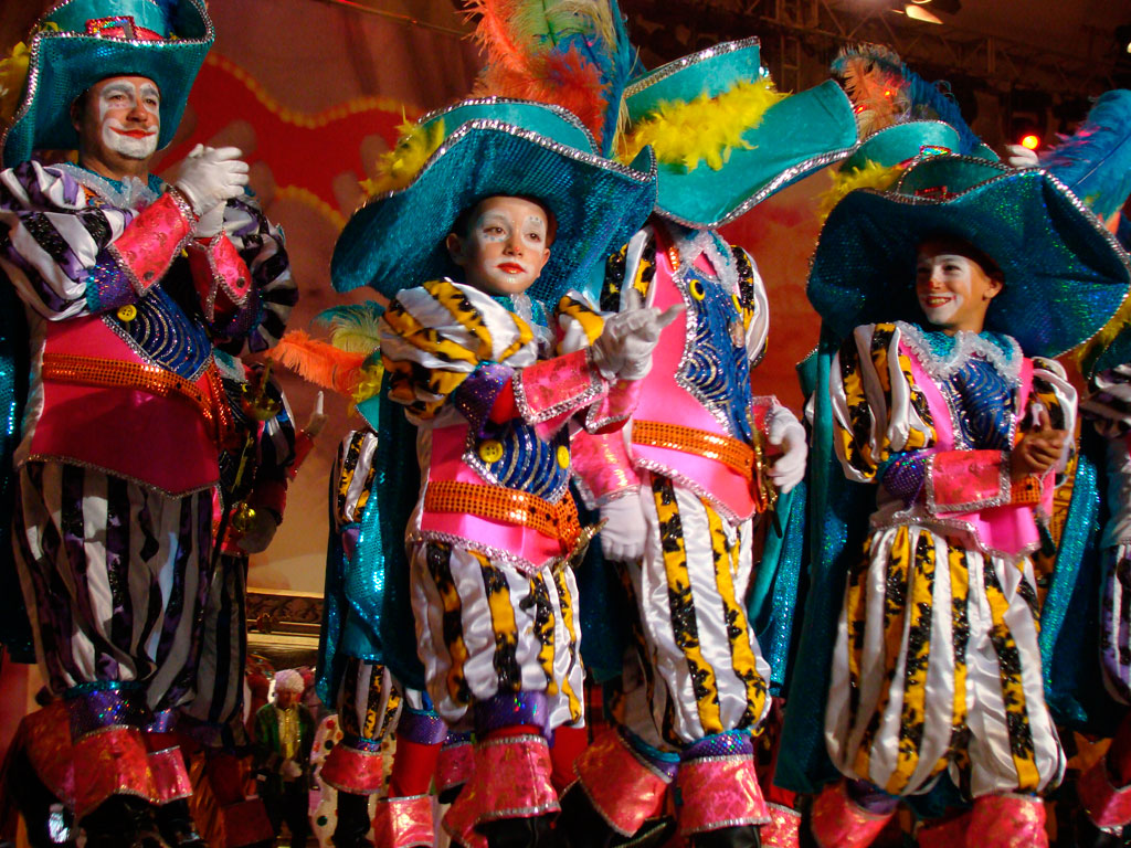 People dressed up at the carnival in Tenerife, wearing colorful and bright costumes.