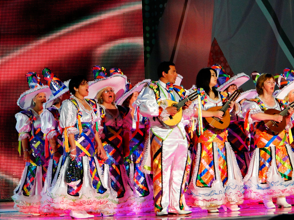 Musical group dressed in colorful costumes performs during Carnival in Tenerife.